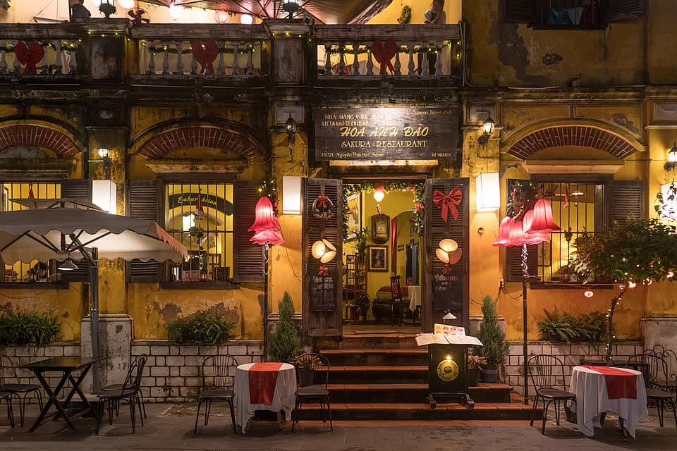 A lantern-hung restaurant terrace in the Old Town at night